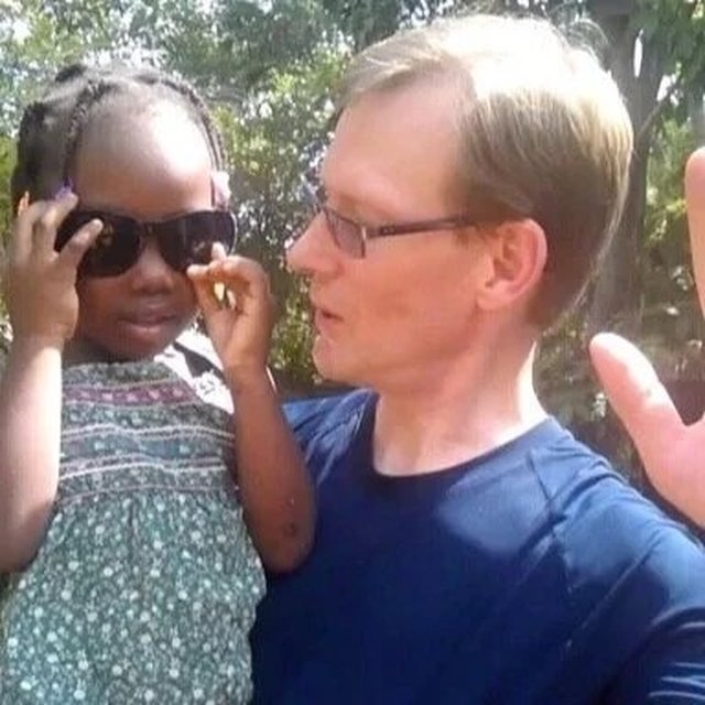 John with a child during a medical mission trip